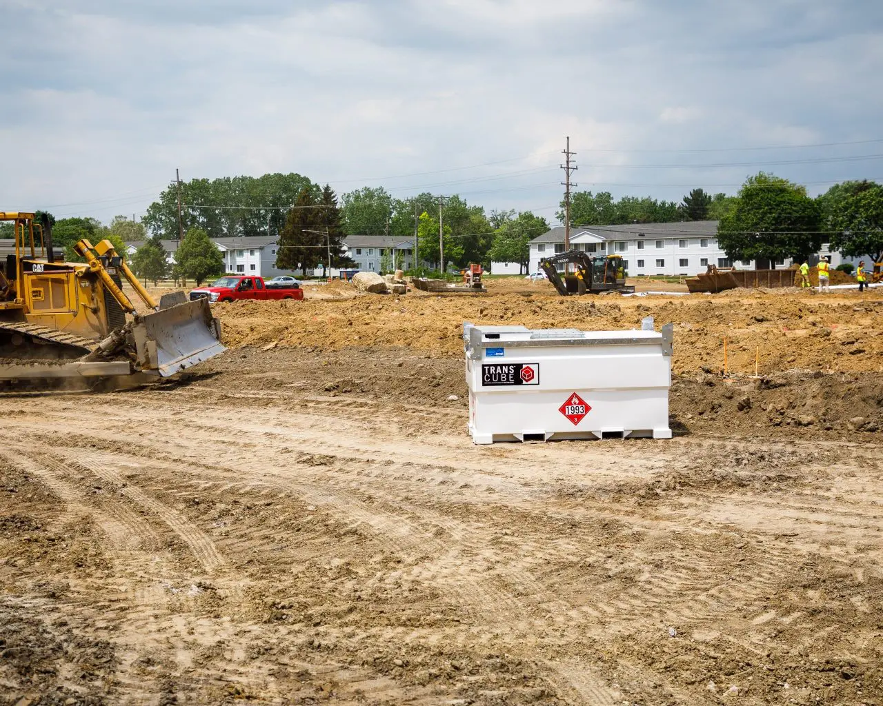 TransCube fuel tank positioned on a construction site beside heavy equipment, supporting safe diesel storage and efficient on-site refuelling.