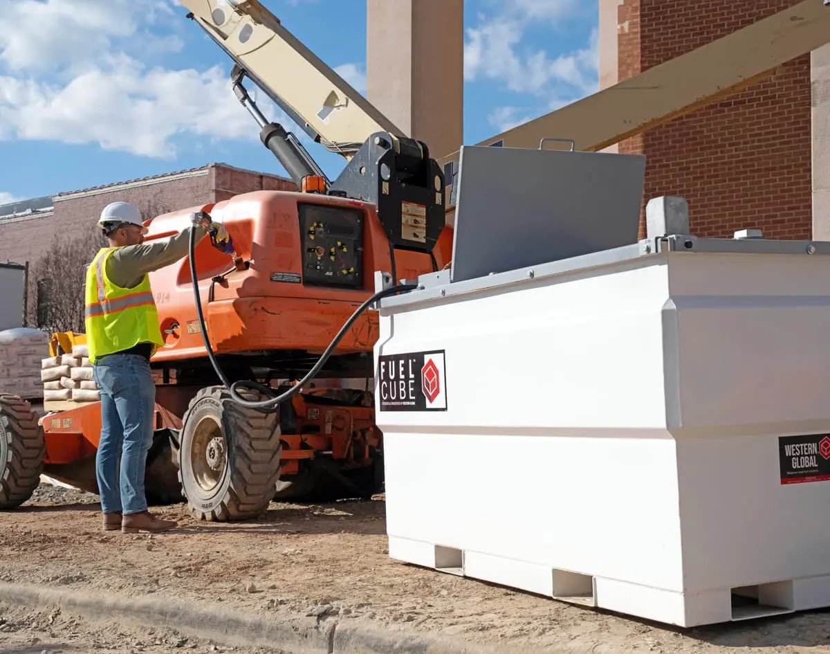 construction worker refueling a tractor with a FuelCube tank